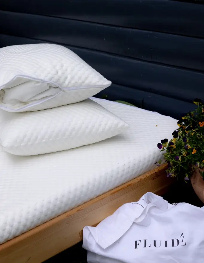 premium pillow protector with breathable, moisture-wicking cotton surface, shields against sweat, spills, and allergens.